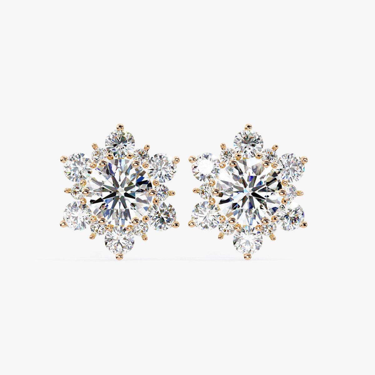 Rose gold floral cluster earrings displayed from a top-down angle, showing prong-set diamonds and rounded symmetry.