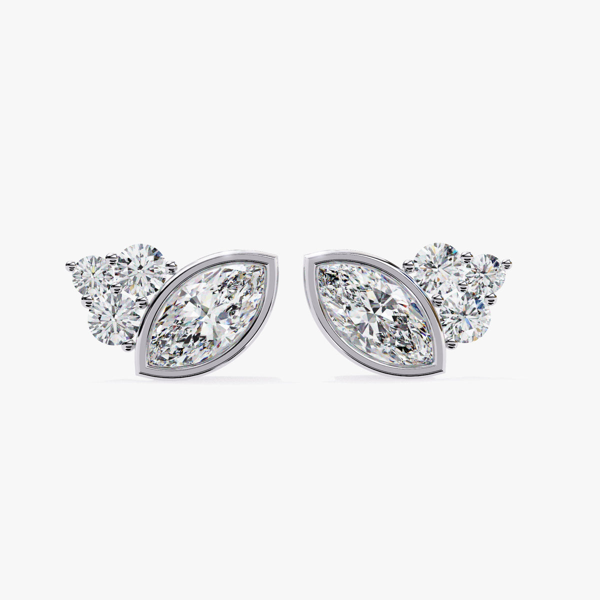 A pair of 14k white gold stud earrings featuring marquise-cut lab-grown diamonds in the center, flanked by three smaller round diamonds in a three-stone setting.