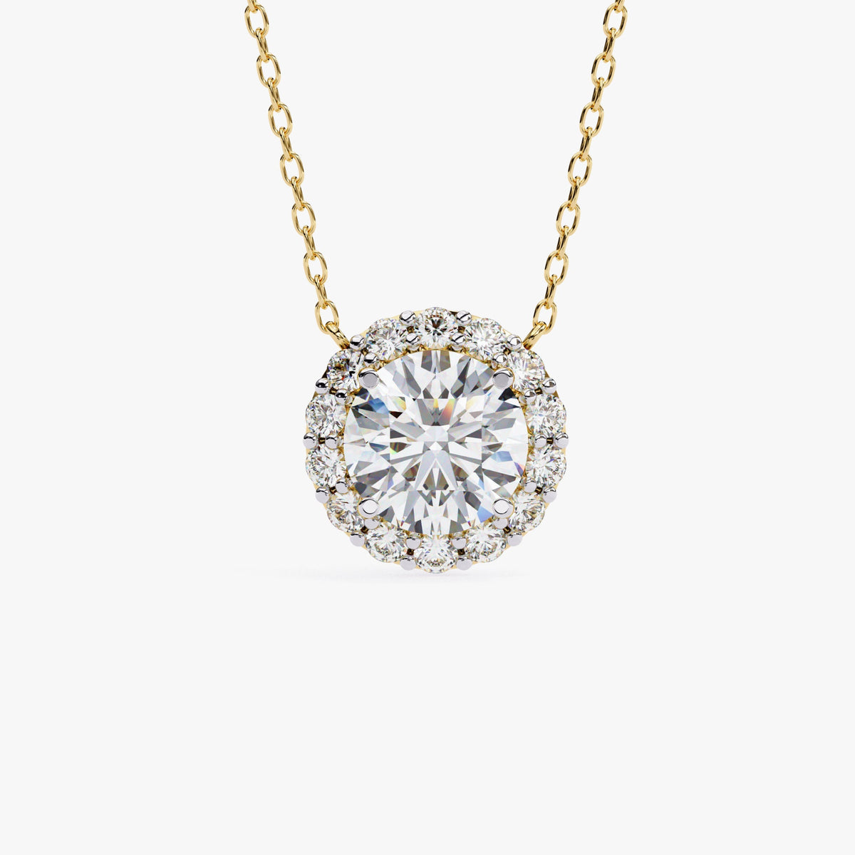 A gold chain necklace with a round pendant featuring a single, clear, round-cut stone surrounded by a halo of smaller, clear stones.