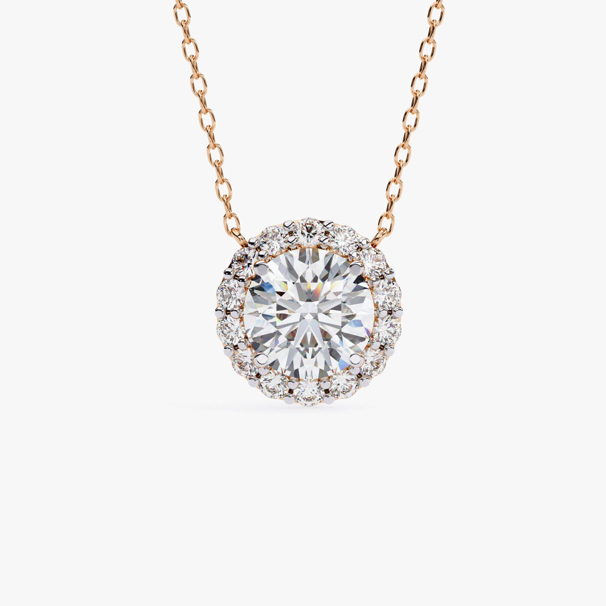 A rose gold chain necklace with a round pendant featuring a single, clear, round-cut stone surrounded by a halo of smaller, clear stones.
