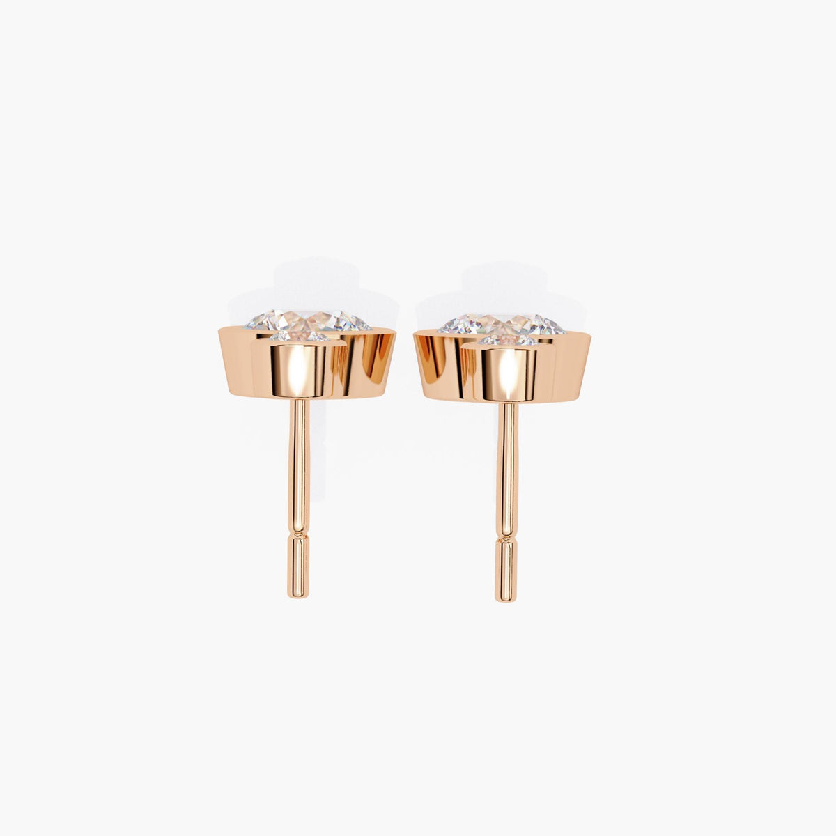 Side profile of 14k rose gold diamond drop earrings, showing bezel-set lab grown diamonds and straight posts. Highlights the sturdy construction and depth of setting, ideal for daily wear or minimalist bridal jewelry.