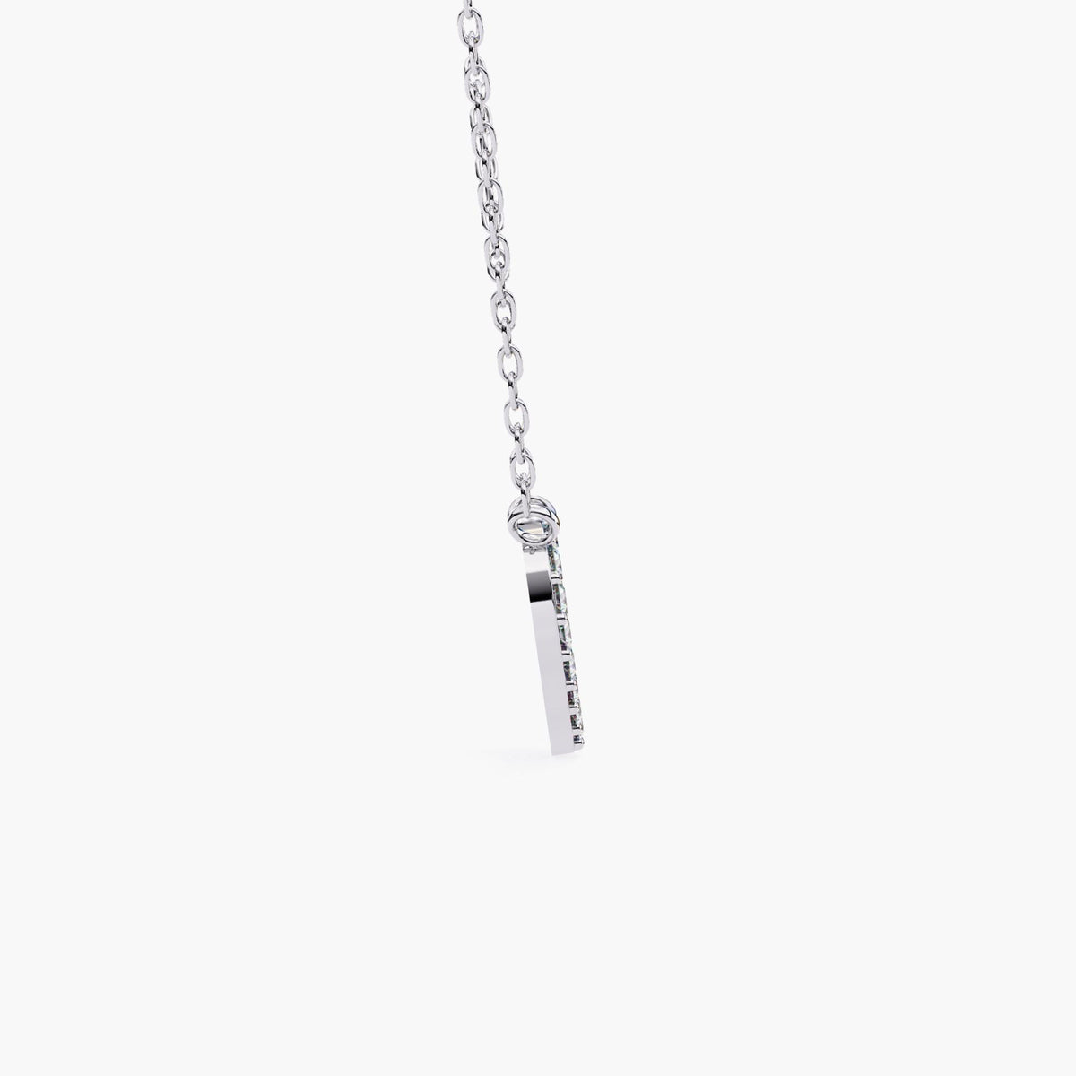 Side profile of a 14k white gold pavé heart necklace showing the slim pendant thickness and polished edge, with diamonds visible along the front face and a fine cable chain attachment.