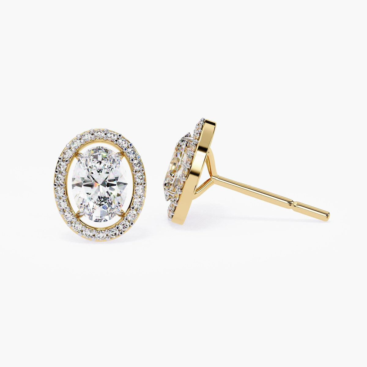 Close-up of 14k yellow gold oval stud earrings featuring a floating halo of round lab-grown diamonds surrounding an oval center stone, with visible prongs and post.