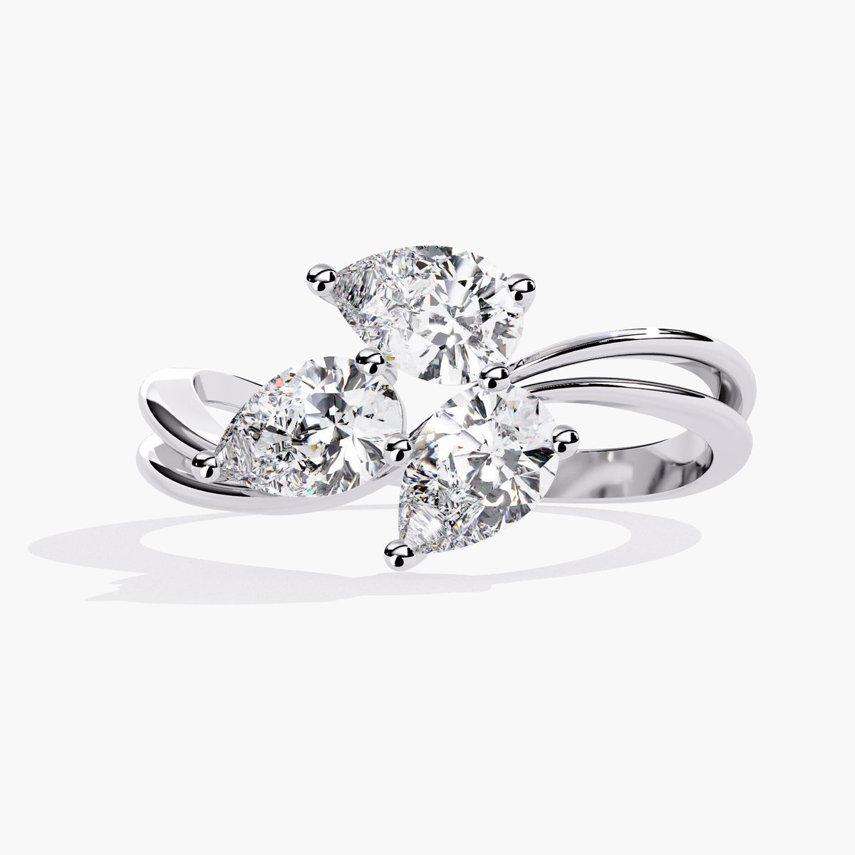 A gold ring with a delicate branch design featuring clear, marquise-shaped stones.