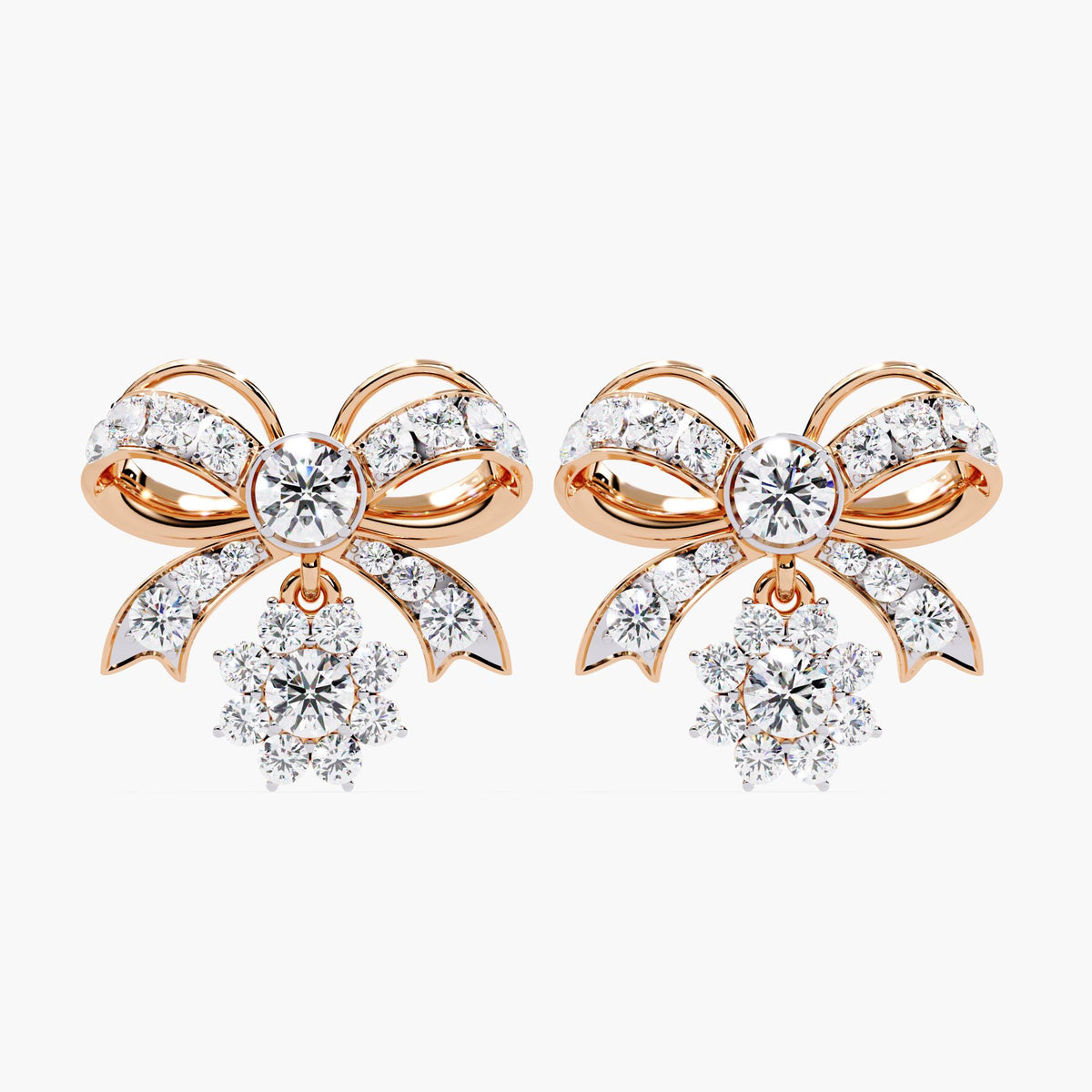 A pair of rose gold bow earrings with dangling clear round diamonds. The bows are made of small clear stones with rose gold accents.