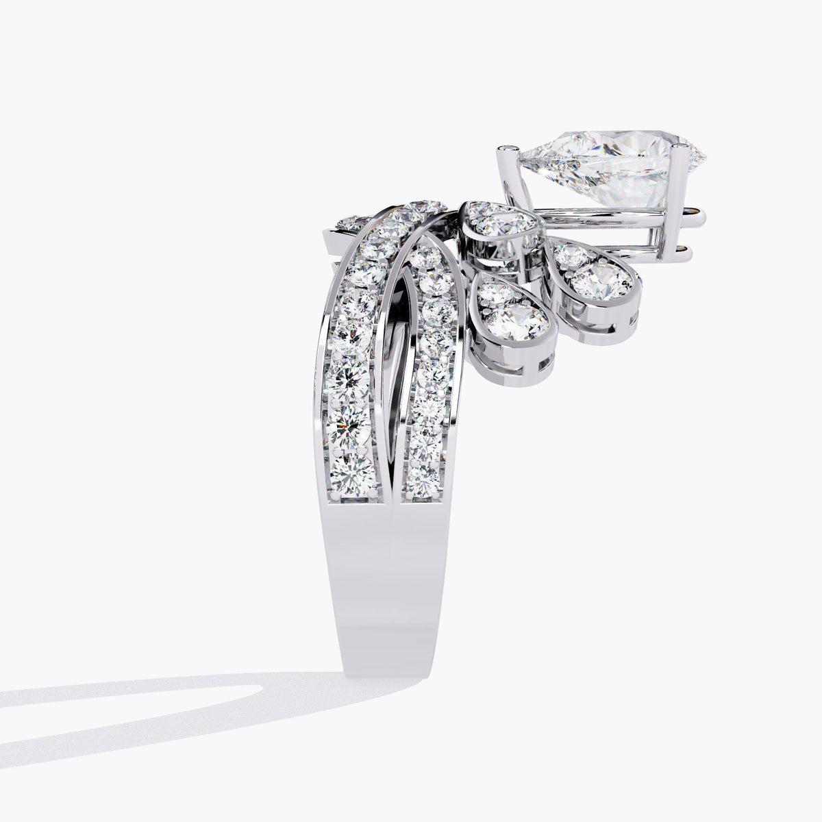 A white gold ring with a pear-shaped diamond center stone and smaller diamonds set in a crown-like design.