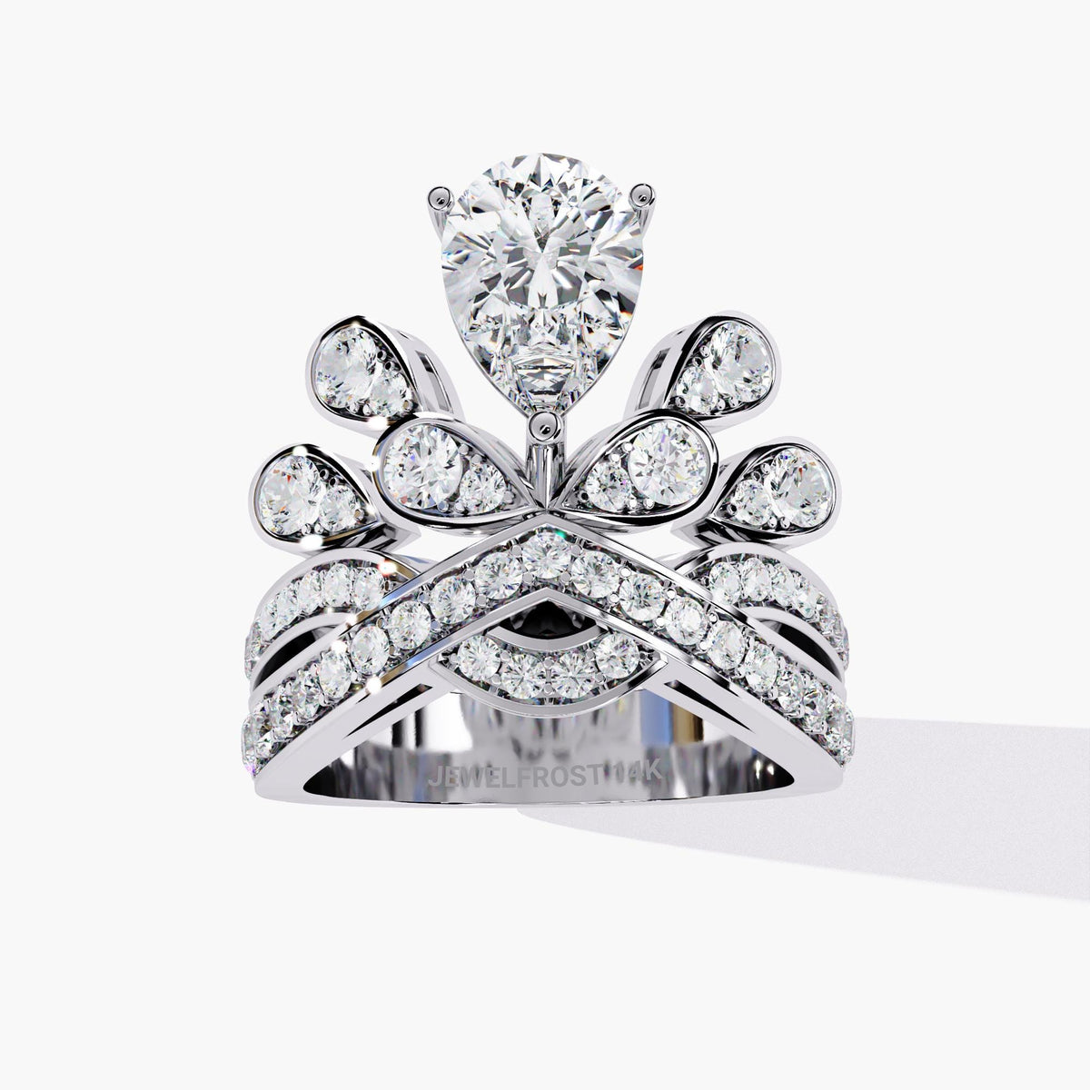 A white gold ring with a pear-shaped diamond center stone and smaller diamonds set in a crown-like design.