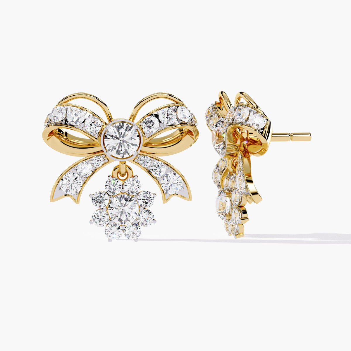 A pair of gold bow earrings with dangling clear round diamonds. The bows are made of small clear stones with gold accents.