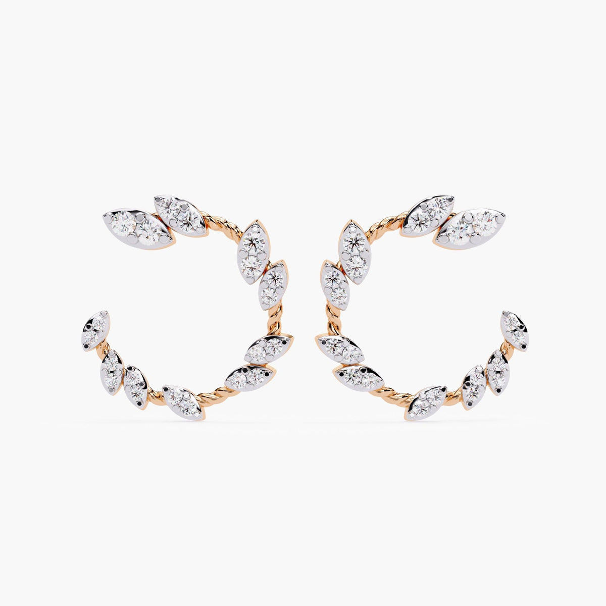 A pair of rose gold earrings with marquise cut diamonds.