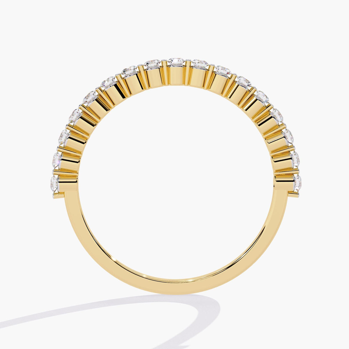 14k yellow gold single prong diamond band, showing the open scalloped edges of the shared prong setting. The diamonds sit above clean gold prongs, creating a modern, structured silhouette with minimal metal visibility.