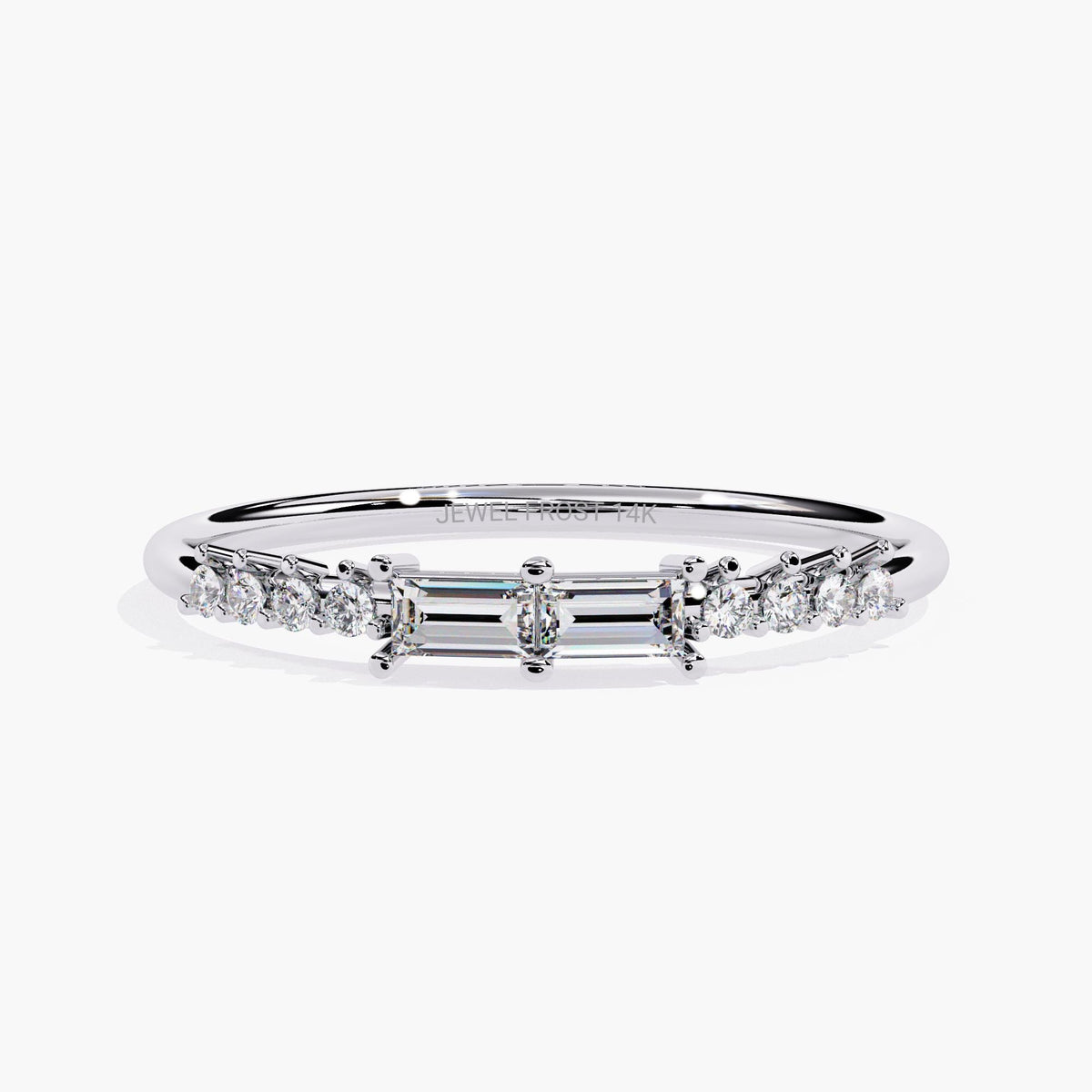 A white gold band ring with a baguette diamond and smaller round diamonds on the band.