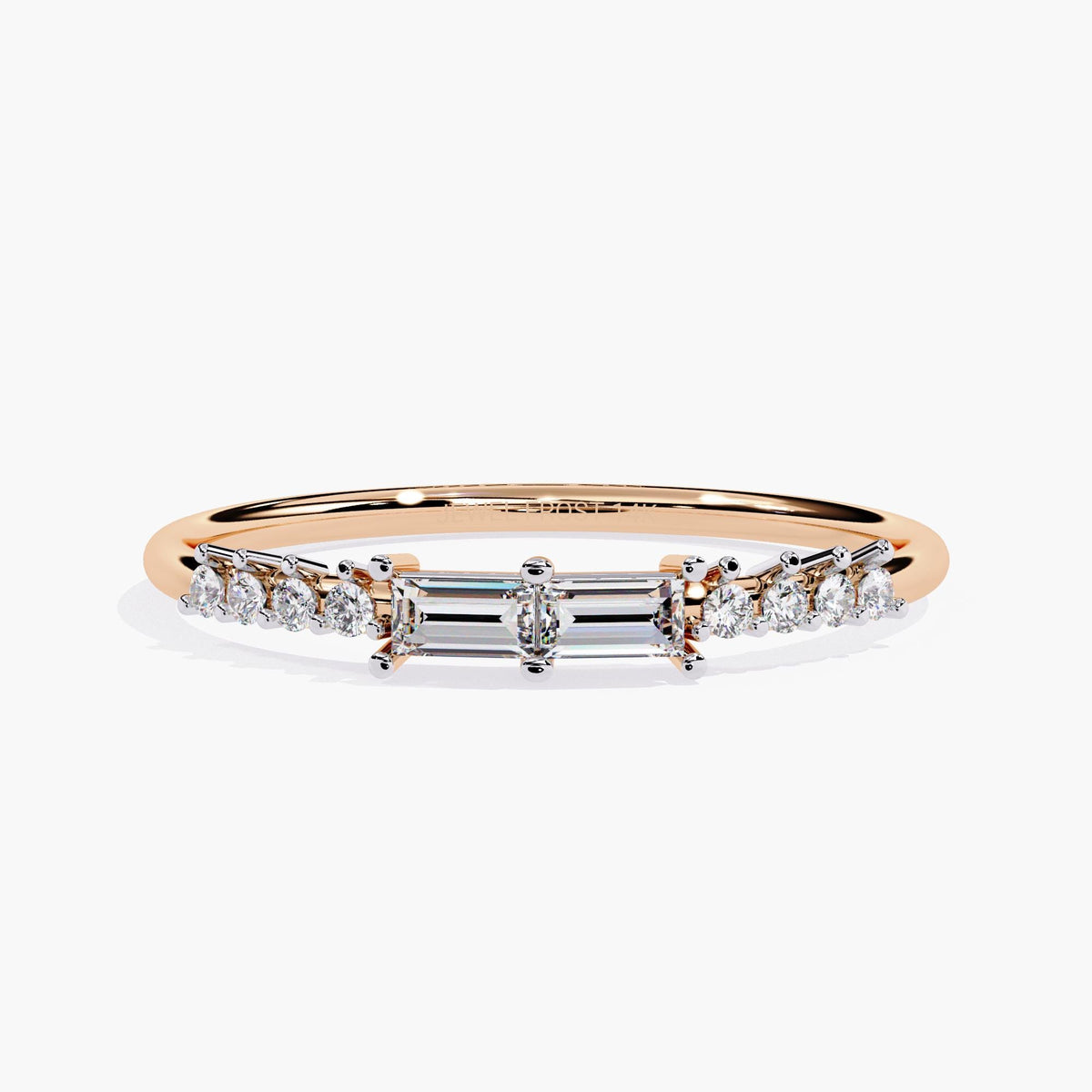 A rose gold band ring with a baguette diamond and smaller round diamonds on the band.