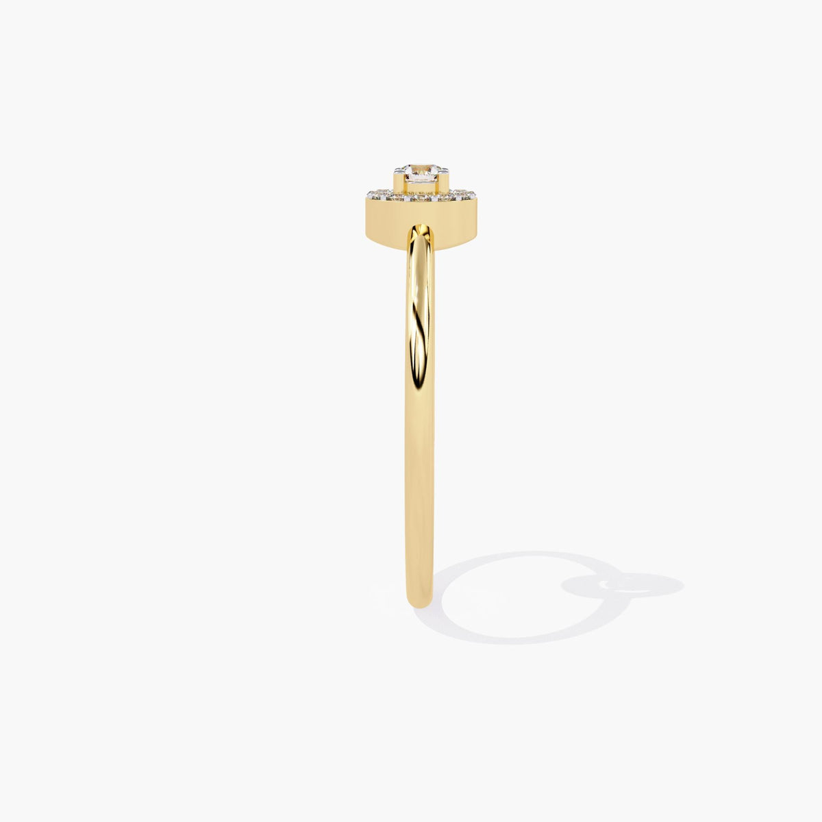 A yellow gold band ring with a single round diamond set in a halo of smaller diamonds.