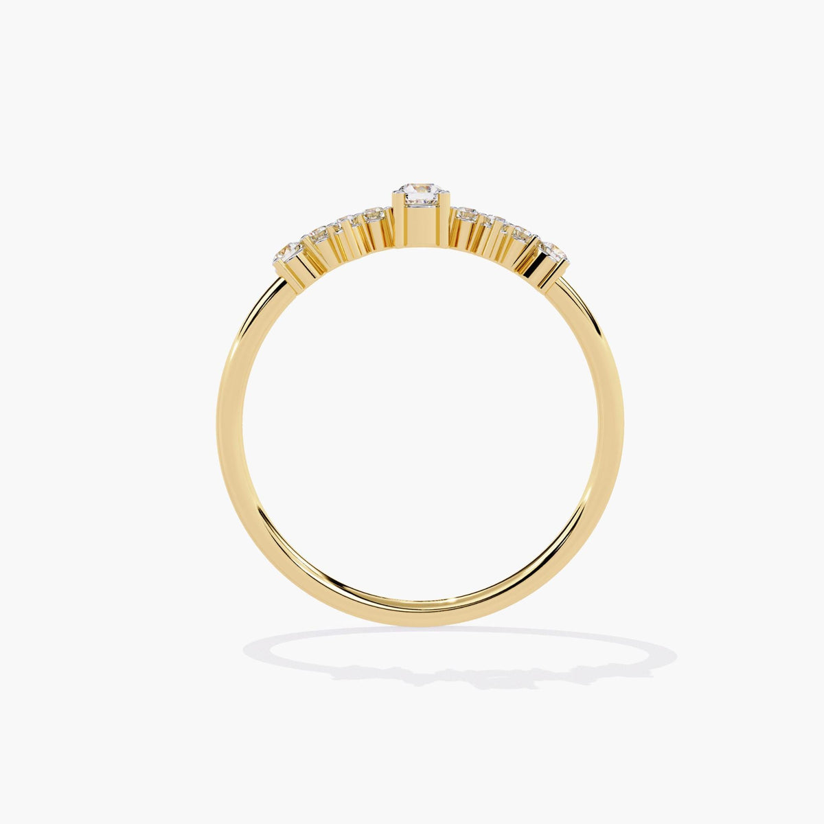 A yellow gold band ring with a cluster of small diamonds and a larger round diamond in the center.