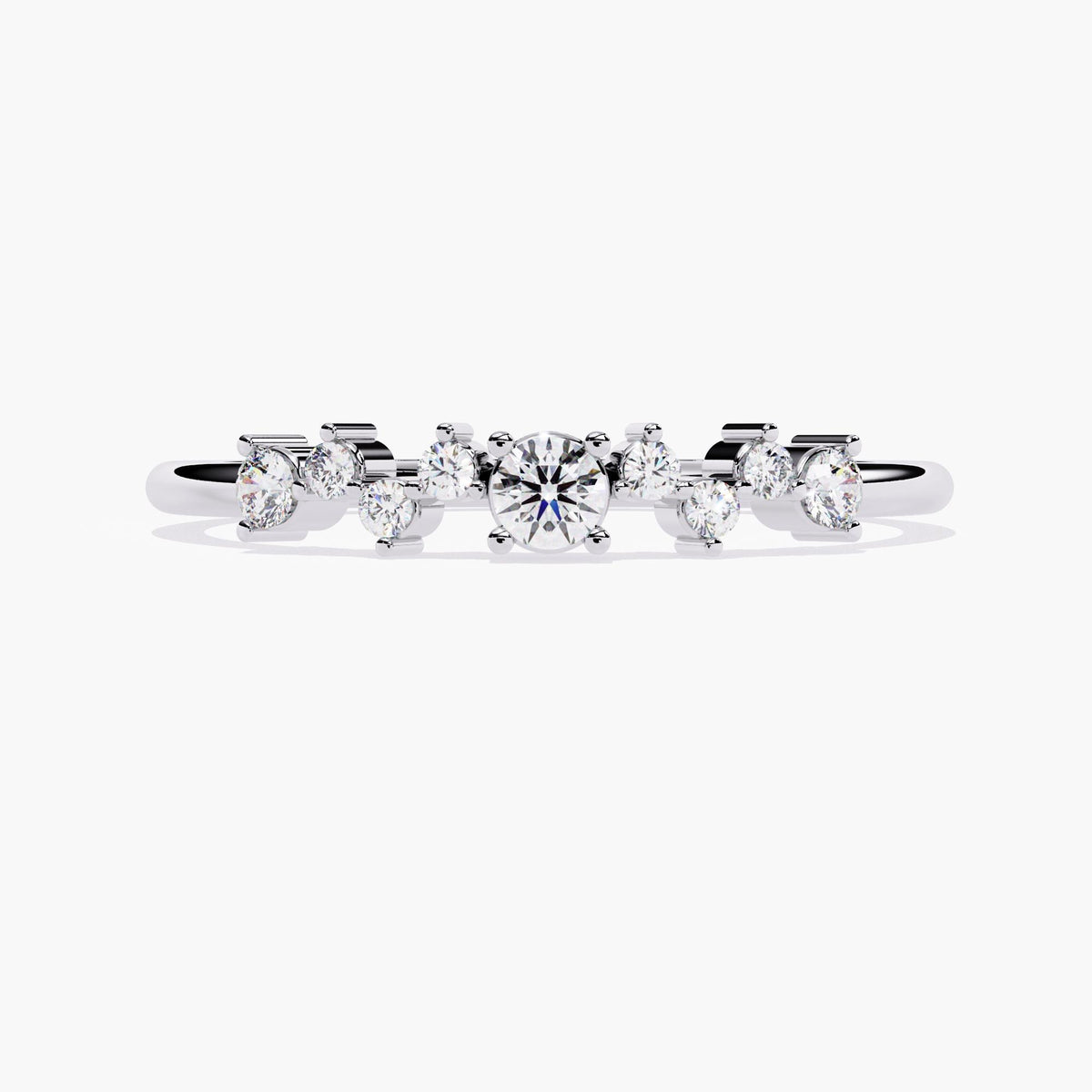 A white gold band ring with a cluster of small diamonds and a larger round diamond in the center.