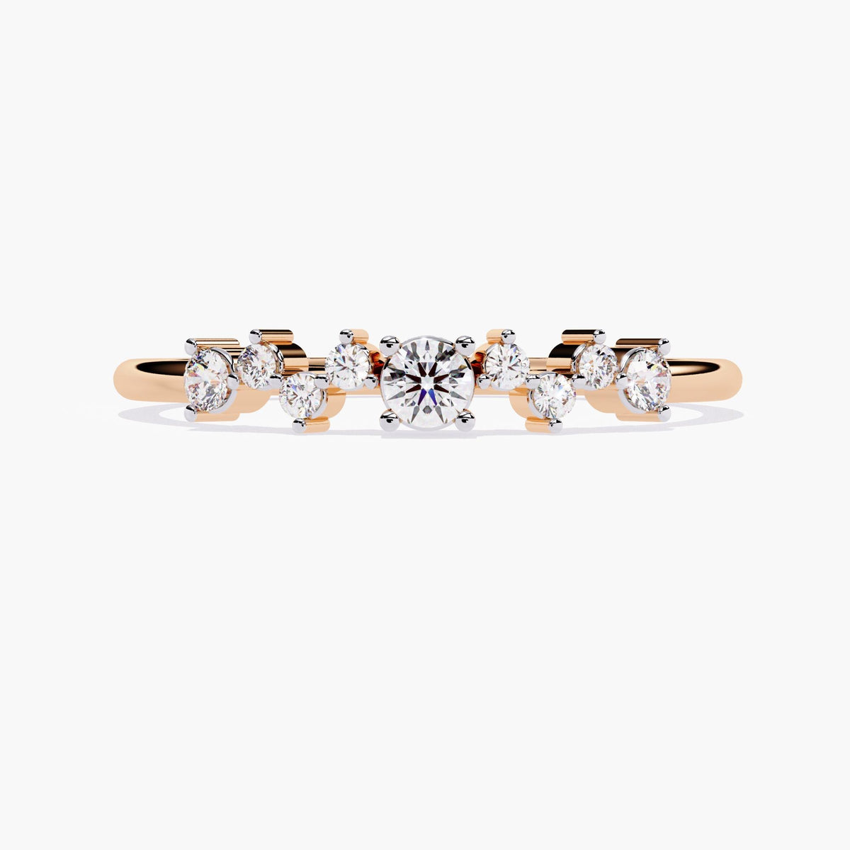 A rose gold band ring with a cluster of small diamonds and a larger round diamond in the center.