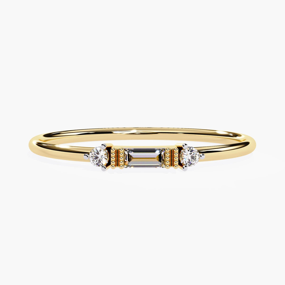 A yellow gold ring featuring a center baguette diamond flanked by two round diamonds, set in a minimalist band with milgrain detail. A thoughtful anniversary or promise ring.