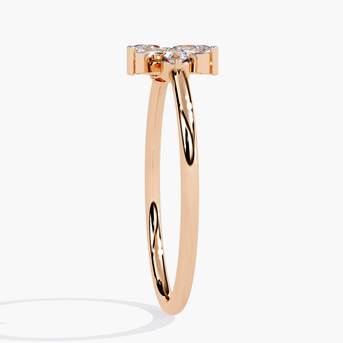 A rose gold ring with a delicate leaf design featuring marquise-shaped diamonds and two round diamonds.