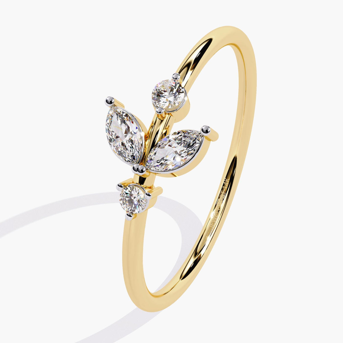 A yellow gold ring with a delicate leaf design featuring marquise-shaped diamonds and two round diamonds.