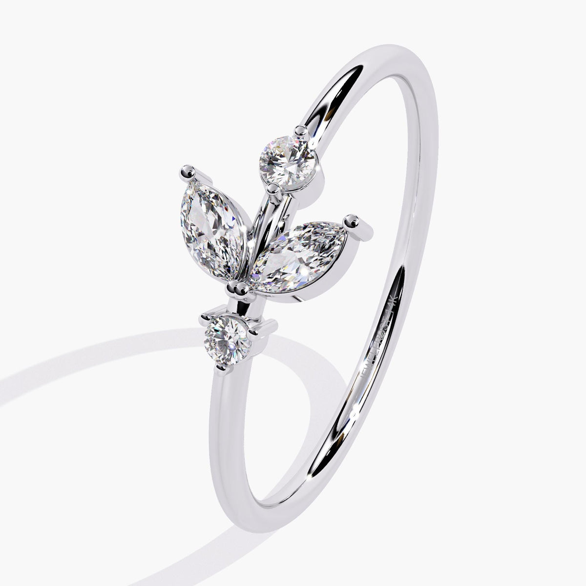 A white gold ring with a delicate leaf design featuring marquise-shaped diamonds and two round diamonds.