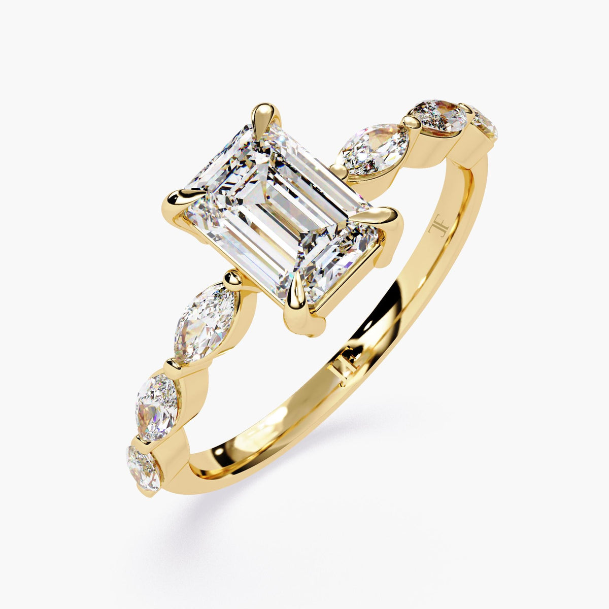 A yellow gold emerald-cut moissanite engagement ring. The ring features a large, radiant emerald-cut moissanite center stone.