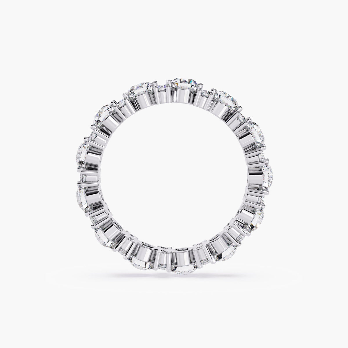 A white gold full eternity ring with round cut diamonds in different sizes.