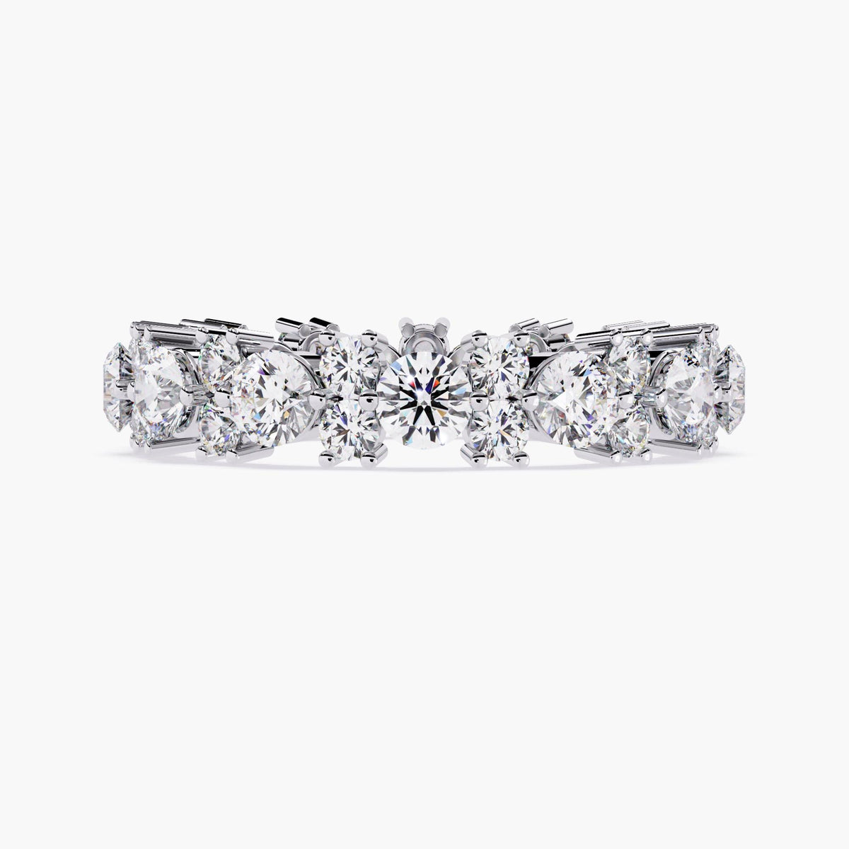 A white gold full eternity ring with round cut diamonds in different sizes.