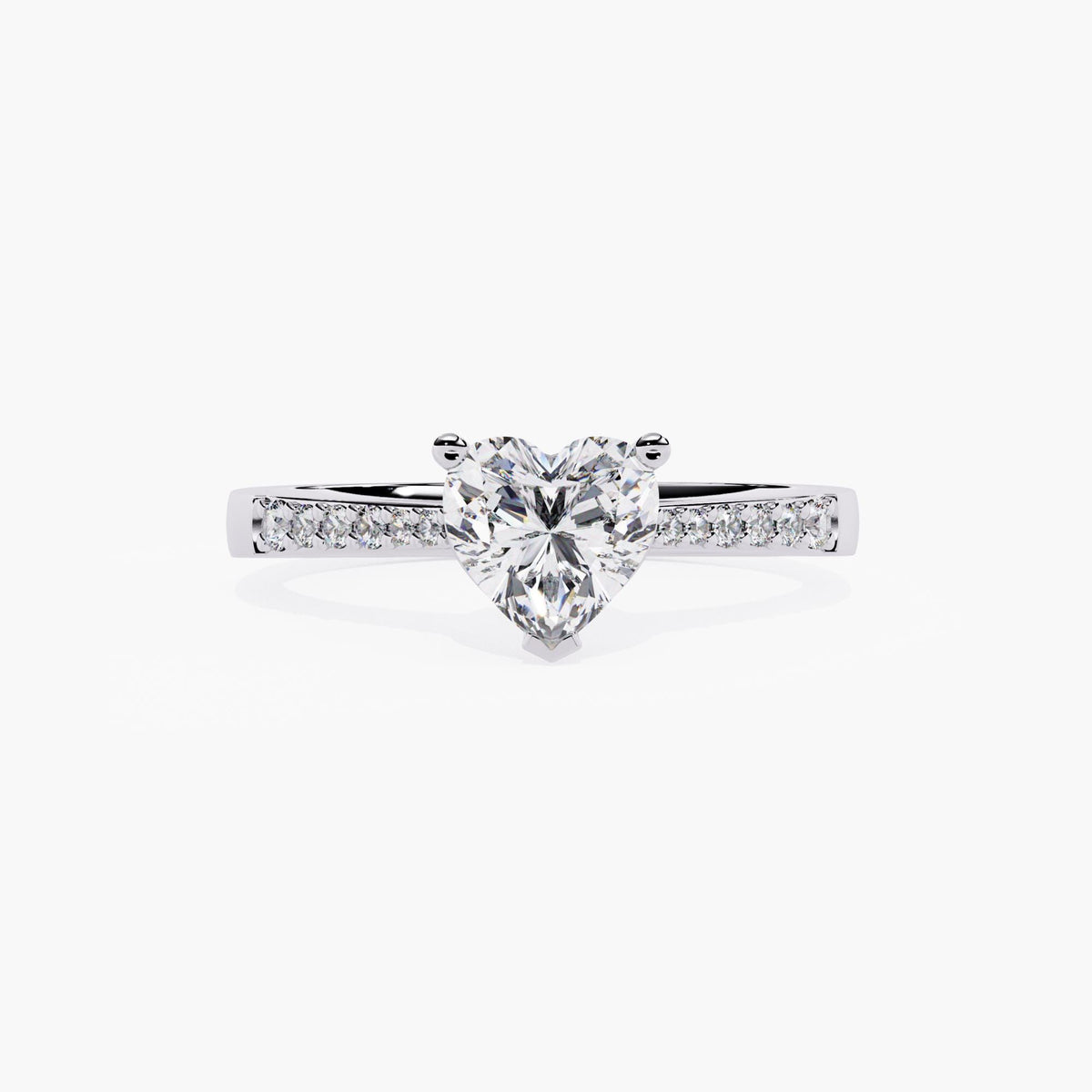 A white gold ring band featuring a heart-shaped diamond center stone, adorned with small round-cut stones on the sides.