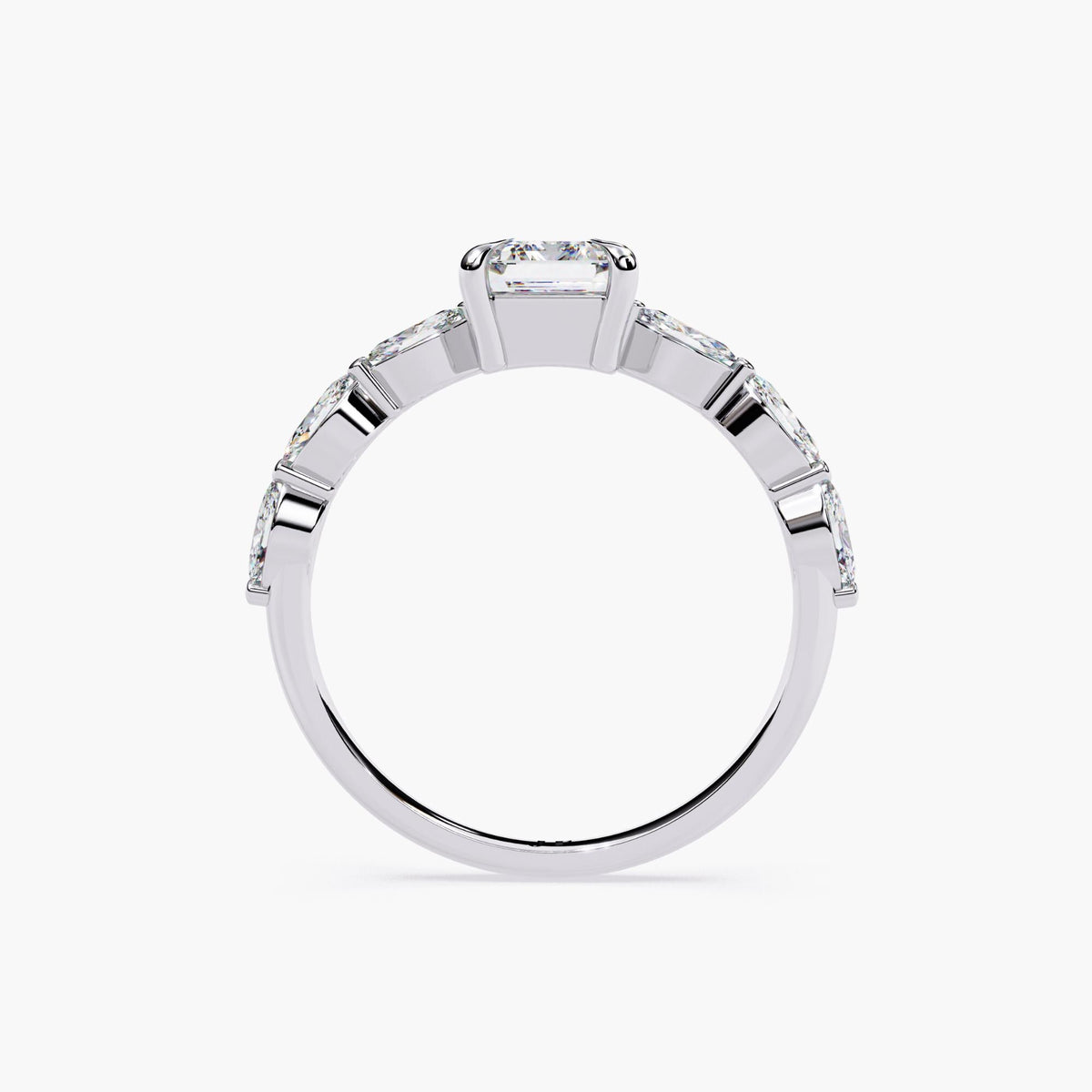 A gold emerald-cut moissanite engagement ring. The ring features a large, radiant emerald-cut moissanite center stone.