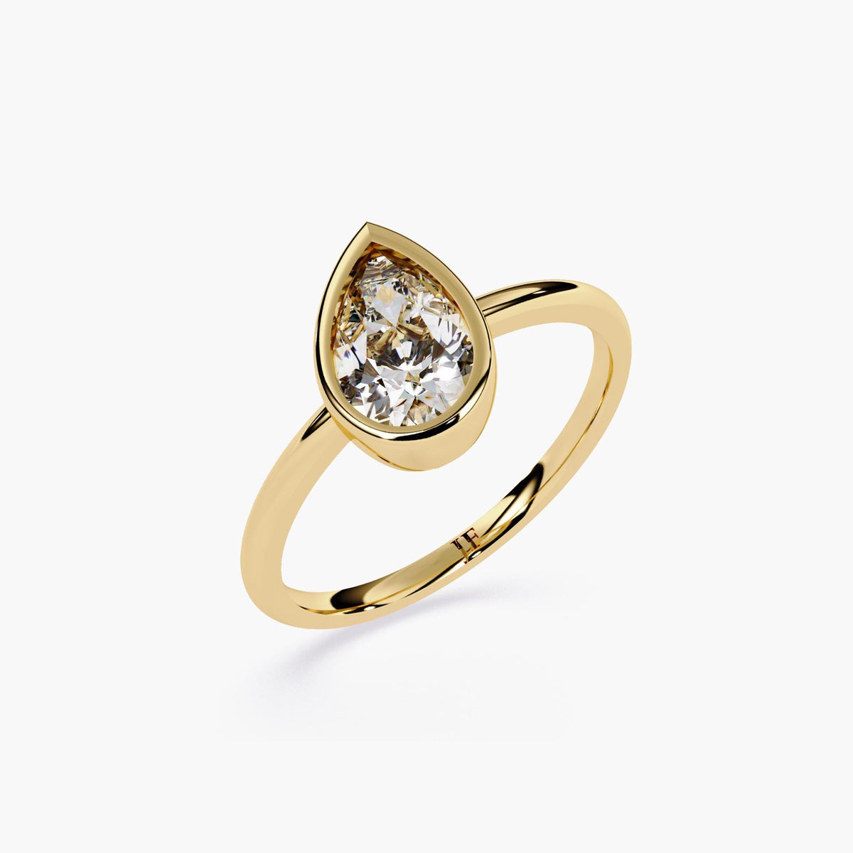 A gold ring with pear cut diamond at the center.