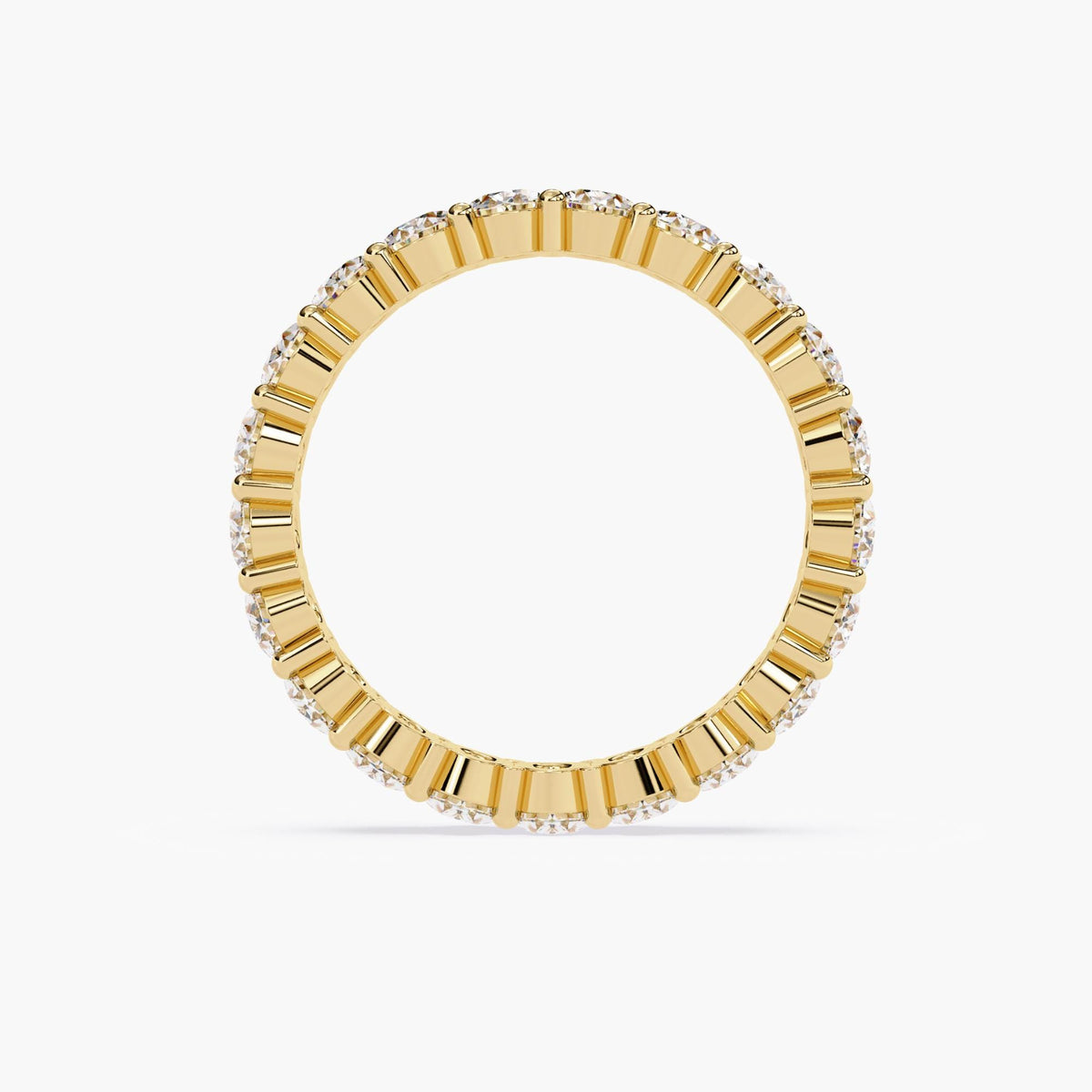A gold band ring with a row of oval shaped diamonds set in a pave setting.