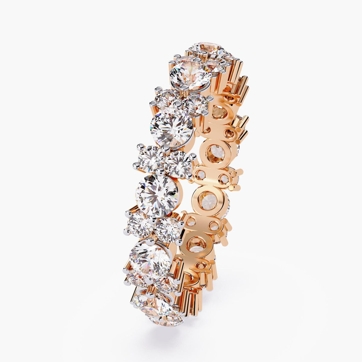 A rose gold full eternity ring with round cut diamonds in different sizes.