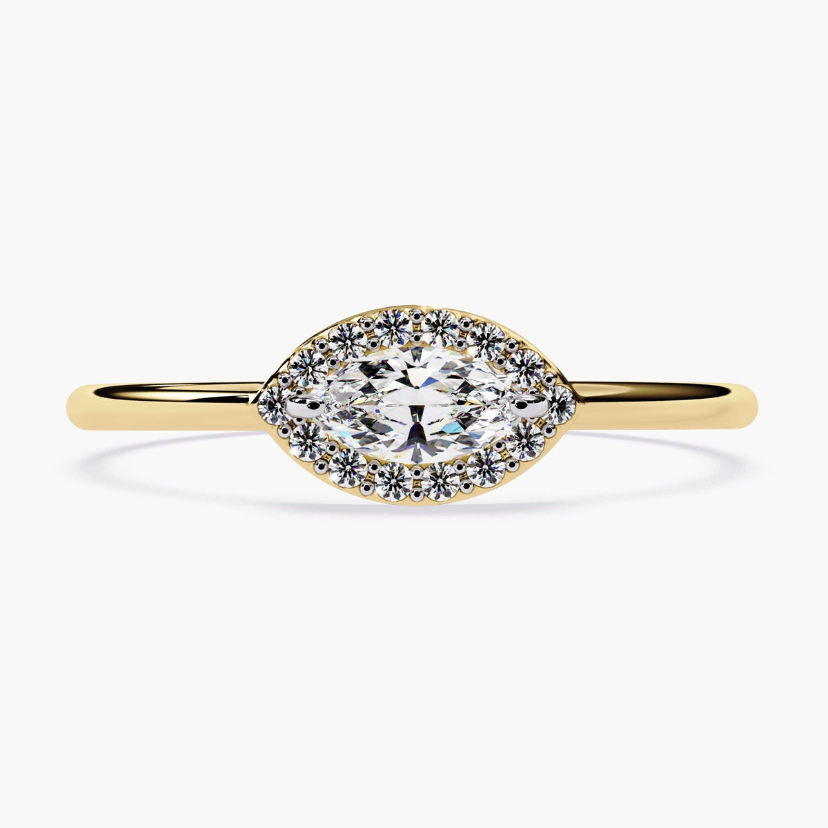 a marquise cut diamond ring in 14k yellow gold with a halo of small round diamonds surrounding the center stone in an eye-shaped design.