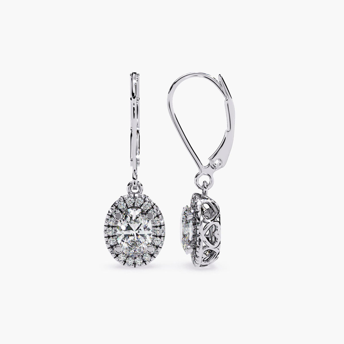 A pair of 14K white gold leverback earrings with oval lab-grown center diamonds surrounded by a halo of round diamonds. The side view highlights a heart-shaped filigree gallery, adding vintage elegance to the drop design.