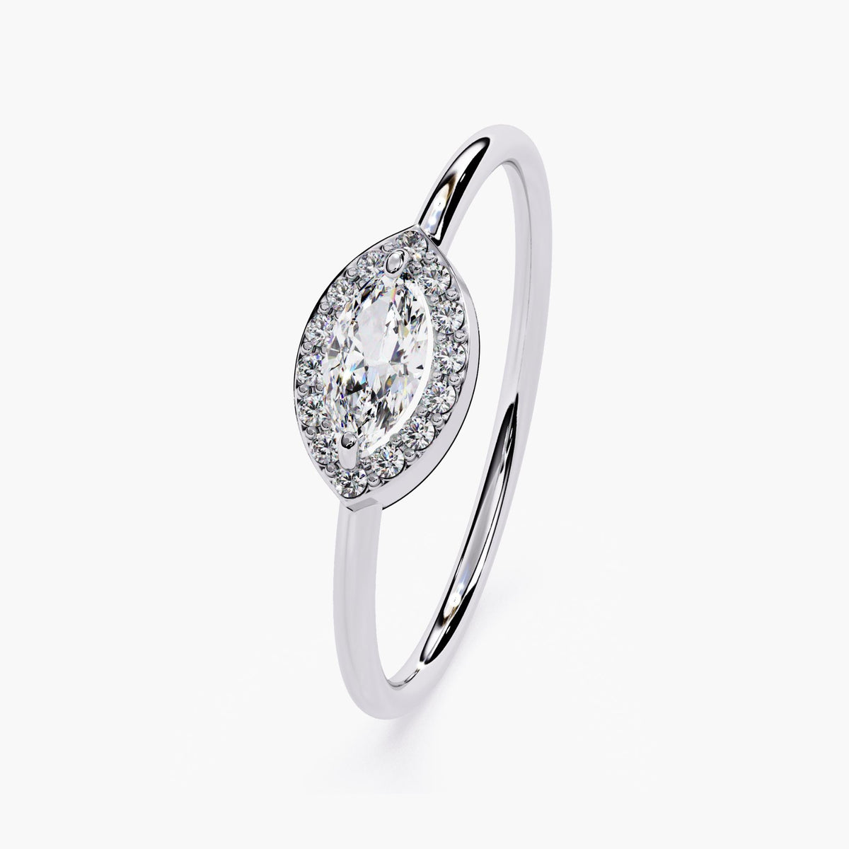 14K white gold east-west marquise halo ring featuring a 6x3mm marquise diamond surrounded by small round diamonds. The dainty band and low-profile setting create a lightweight, everyday wear look with a modern, elegant feel.