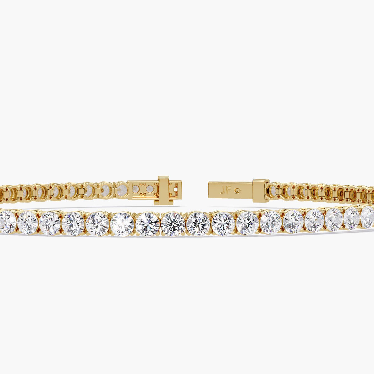 Front view of a 14K yellow gold tennis bracelet featuring a row of round cut natural diamonds, shown open to highlight the clasp design and “JF” logo engraving.