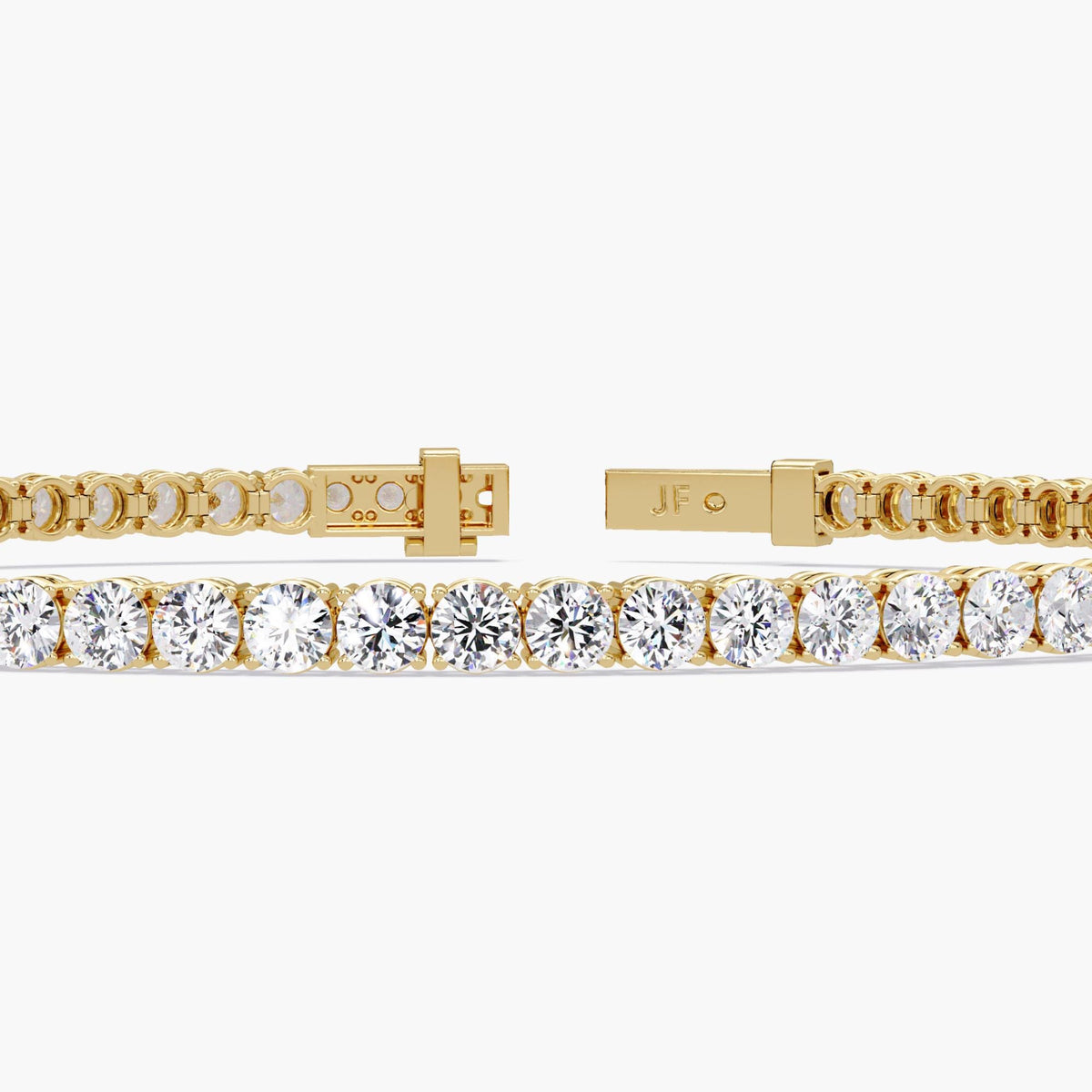 Close-up of a 14K yellow gold diamond tennis bracelet with round cut natural diamonds, shown open to display the secure clasp and “JF” engraved hallmark. The bracelet highlights the brilliance and uniformity of the diamonds.