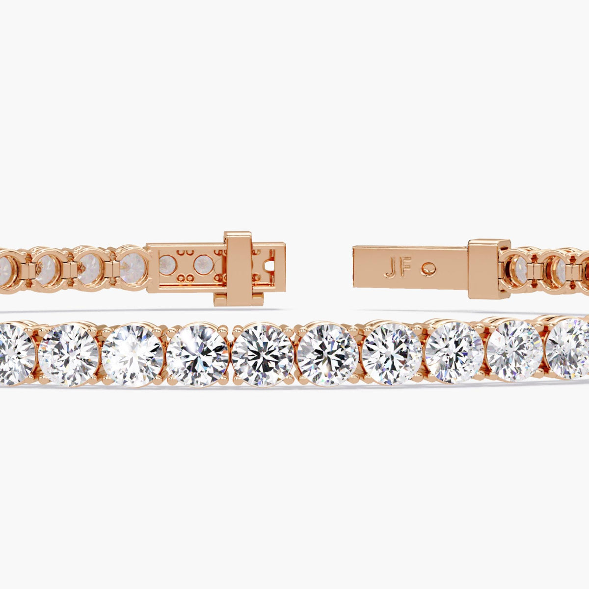 Close-up of a 14K rose gold diamond tennis bracelet with round cut natural diamonds and a secure clasp, featuring the “JF” logo engraving.