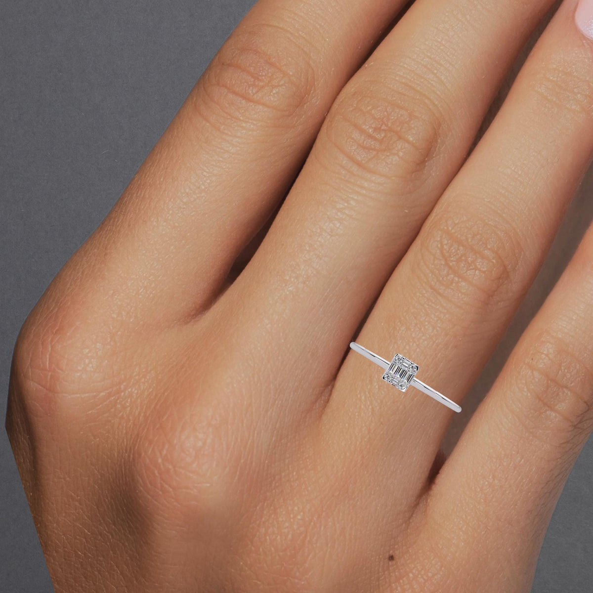 Dainty baguette and round diamond ring worn on hand for scale
