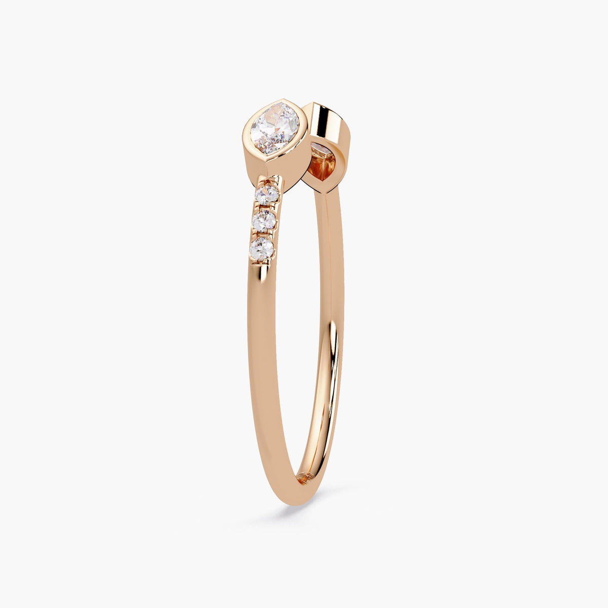 14K rose gold open ring featuring a marquise diamond set in a bezel setting with three small round diamonds on the side of the band, designed for a minimalist look.