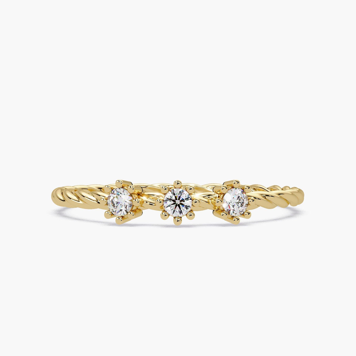 Front view of a 14k yellow gold twisted band ring featuring three small round natural diamonds in six-prong floral settings.