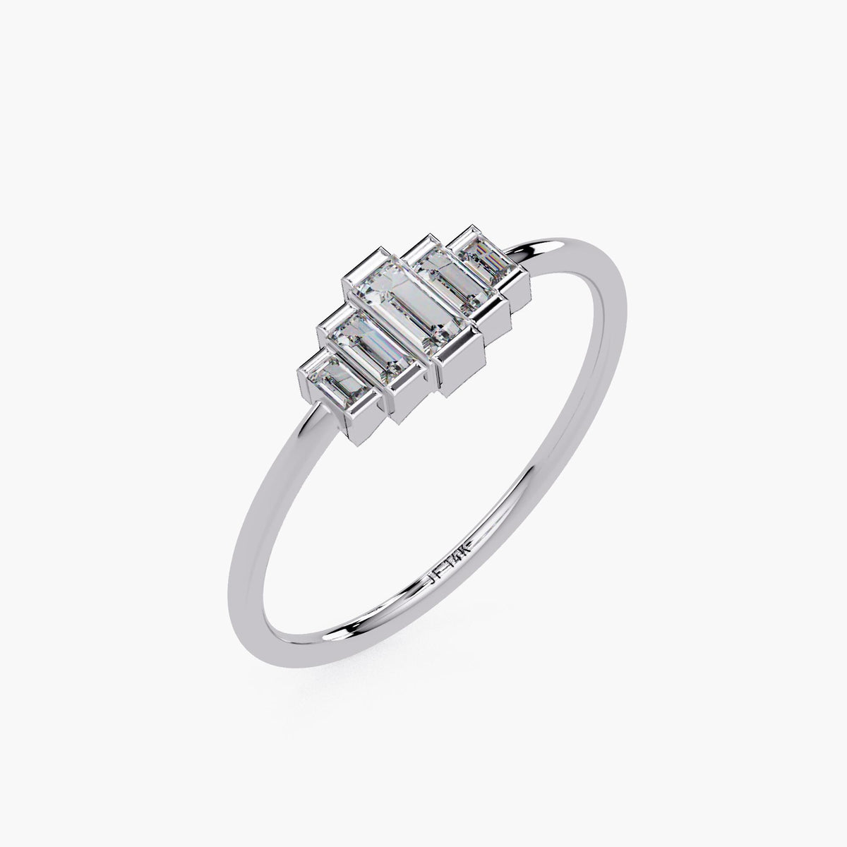 Angled view of a 14k white gold baguette diamond ring featuring a stepped half bezel setting and slim polished band, engraved with 'JF 14K' on the inside.