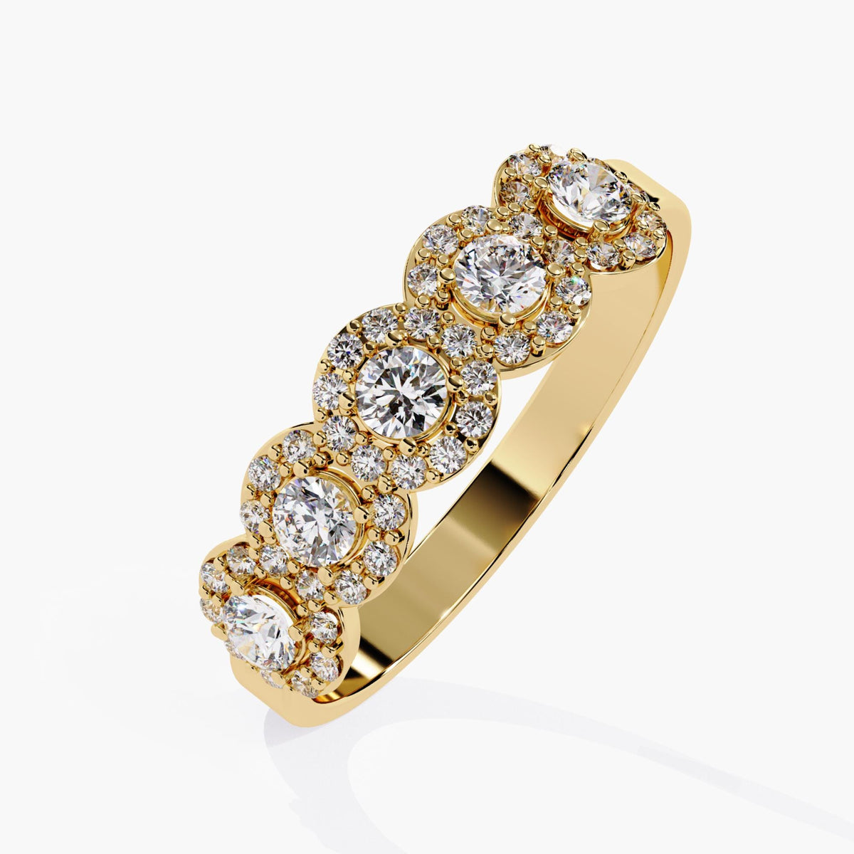 Angled view of a 14k yellow gold band with five round lab-grown diamonds, each surrounded by a halo of smaller diamonds. The raised profile and mirrored gold interior highlight the ring’s bold, structured silhouette, ideal for stacking or wearing as a statement wedding band.