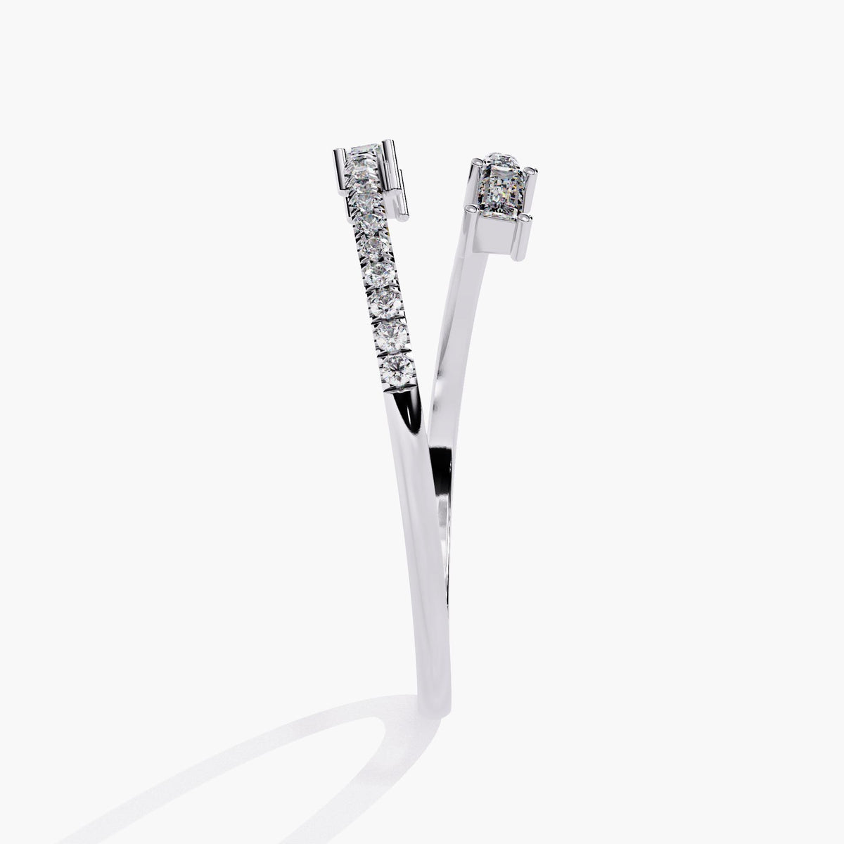Side angle of a 14k white gold bypass ring showing tapering arms with pavé-set round diamonds and step-cut baguette diamonds at each open end.
Designed to layer easily with other slim bands or wear on its own.
Suitable for daily wear, gifting, or as a modern stacking piece.