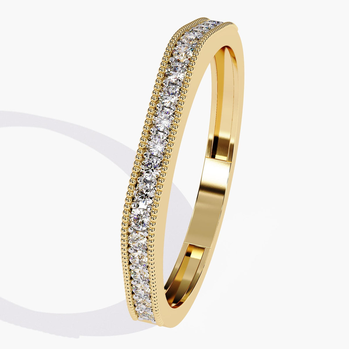 Angled view of a 14k yellow gold flat-top ring featuring a single row of lab-grown round diamonds bordered by fine milgrain detailing. Designed for daily wear, it functions as both a stackable band and a refined wedding ring option.