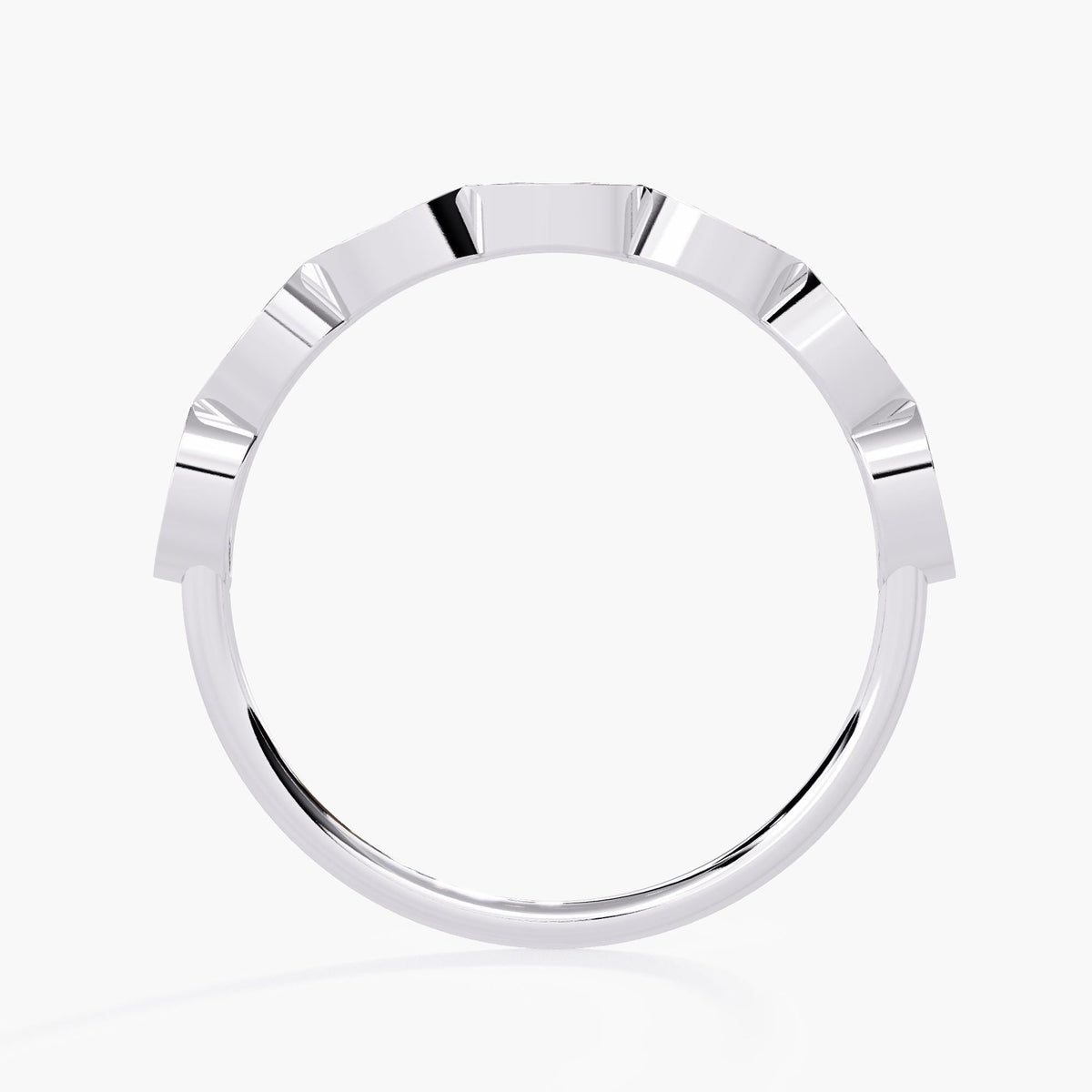 A side view of a sleek white gold band with angular, evenly spaced facets along the top. The clean, geometric design gives the band a modern, sophisticated appearance. This minimalist ring is perfect for adding a contemporary edge to a stack or wearing as a statement piece on its own.