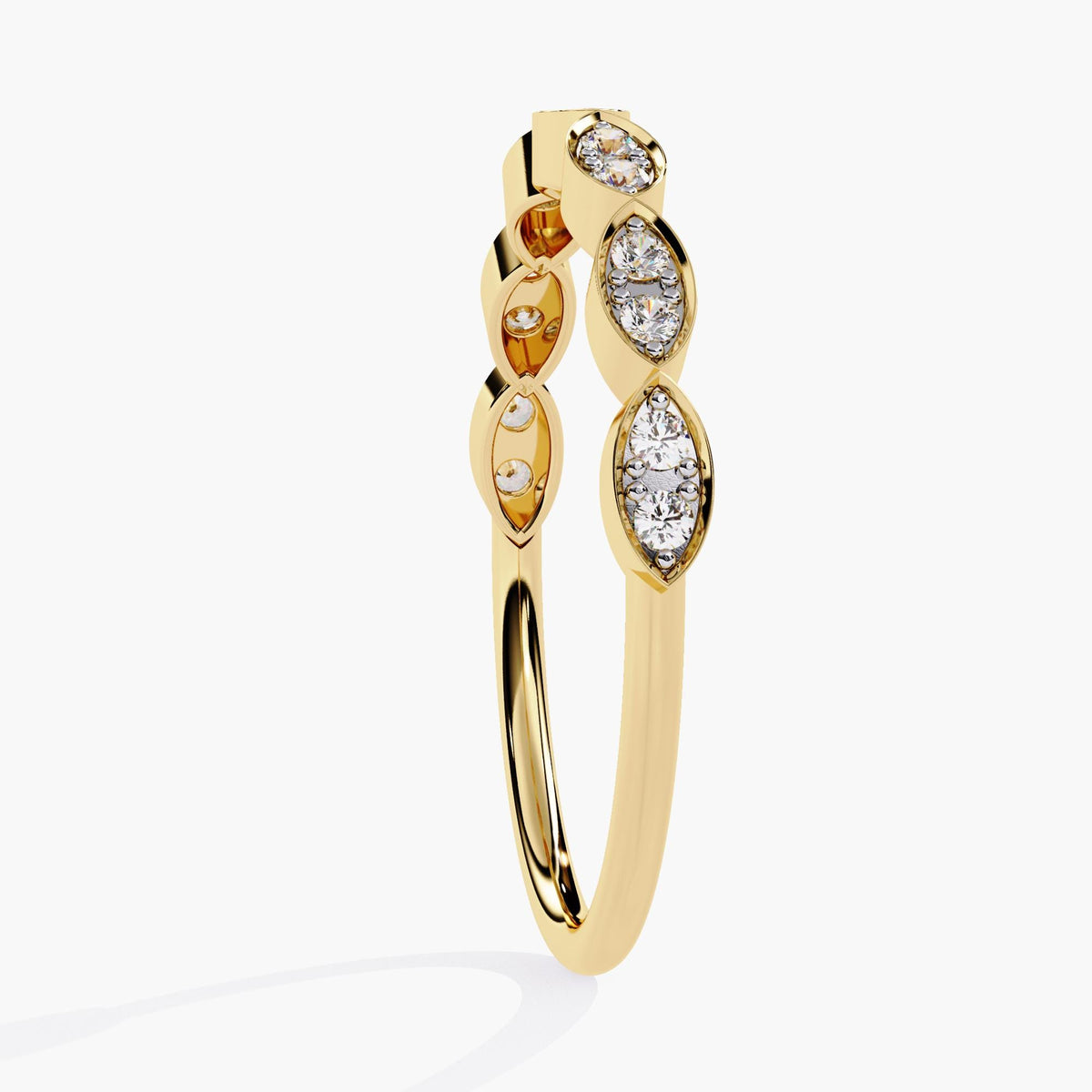 A side view of a yellow gold ring featuring a unique design with marquise-shaped patterns. The ring alternates between sets of bezel-set round diamonds and empty marquise spaces, creating a modern, elegant look. The sleek gold band complements the intricate diamond arrangement, making this piece perfect for stacking or wearing as a standalone statement ring.