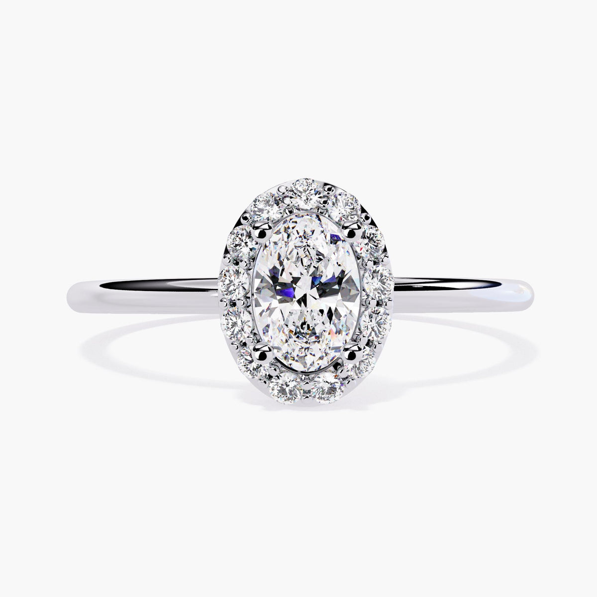 Front view of a 14k white gold oval halo engagement ring featuring a 0.35 ct center lab diamond surrounded by a ring of smaller round diamonds. The band is slim and polished, giving the ring a bright, classic bridal appearance.