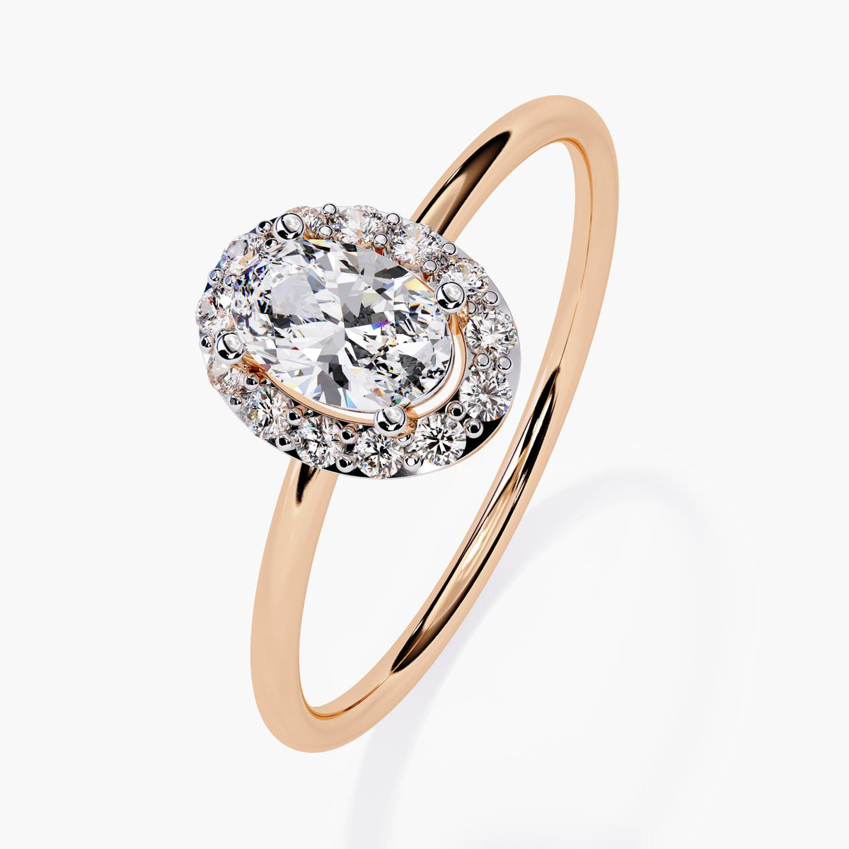 14k rose gold engagement ring featuring a 0.35 ct oval lab-grown diamond in the center, surrounded by a halo of round diamonds. The slim rose gold band complements the vintage-inspired halo setting with a modern touch.