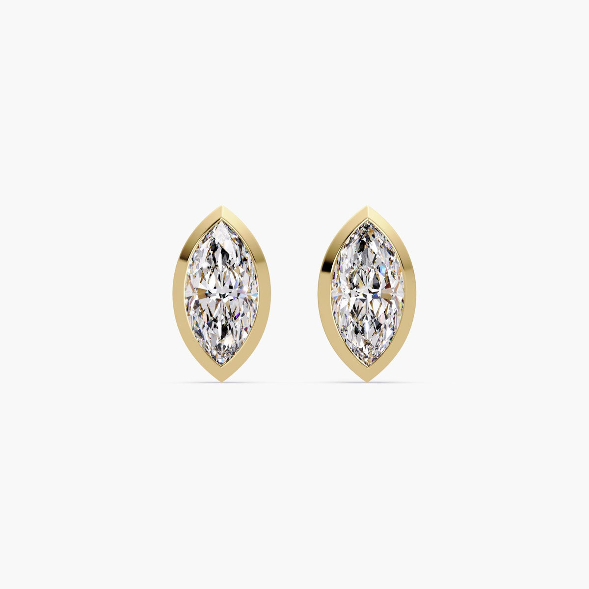 A pair of marquise cut lab grown diamond earrings set in 14k yellow gold with bezel settings. The diamonds have pointed tips and sit flush in a modern, minimal design. These gold studs are lightweight and secure with pushback closures, perfect for everyday wear or special occasions.